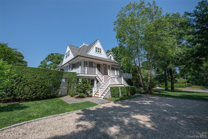 Two-story residence featuring a gray shingle exterior and white trim