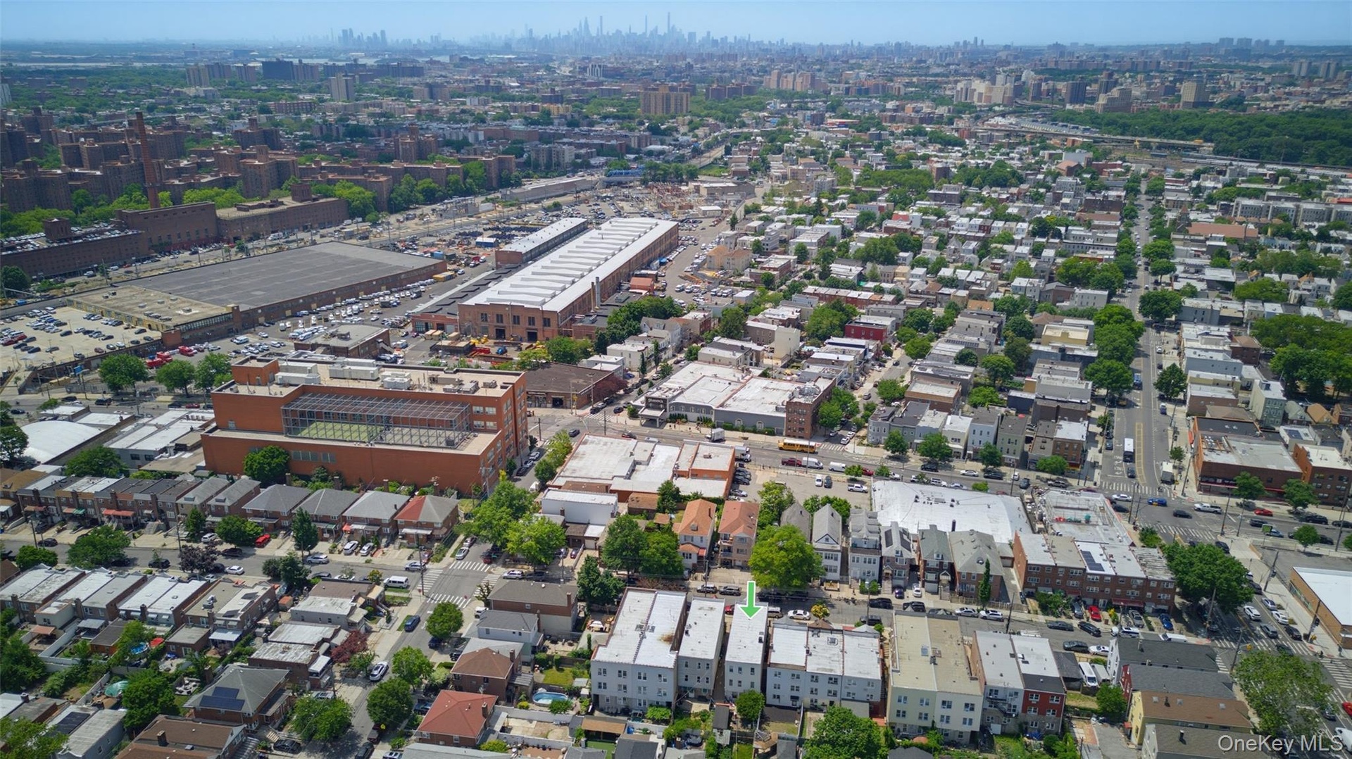 Aerial perspective showcasing the urban landscape with numerous residential structures and commercial buildings