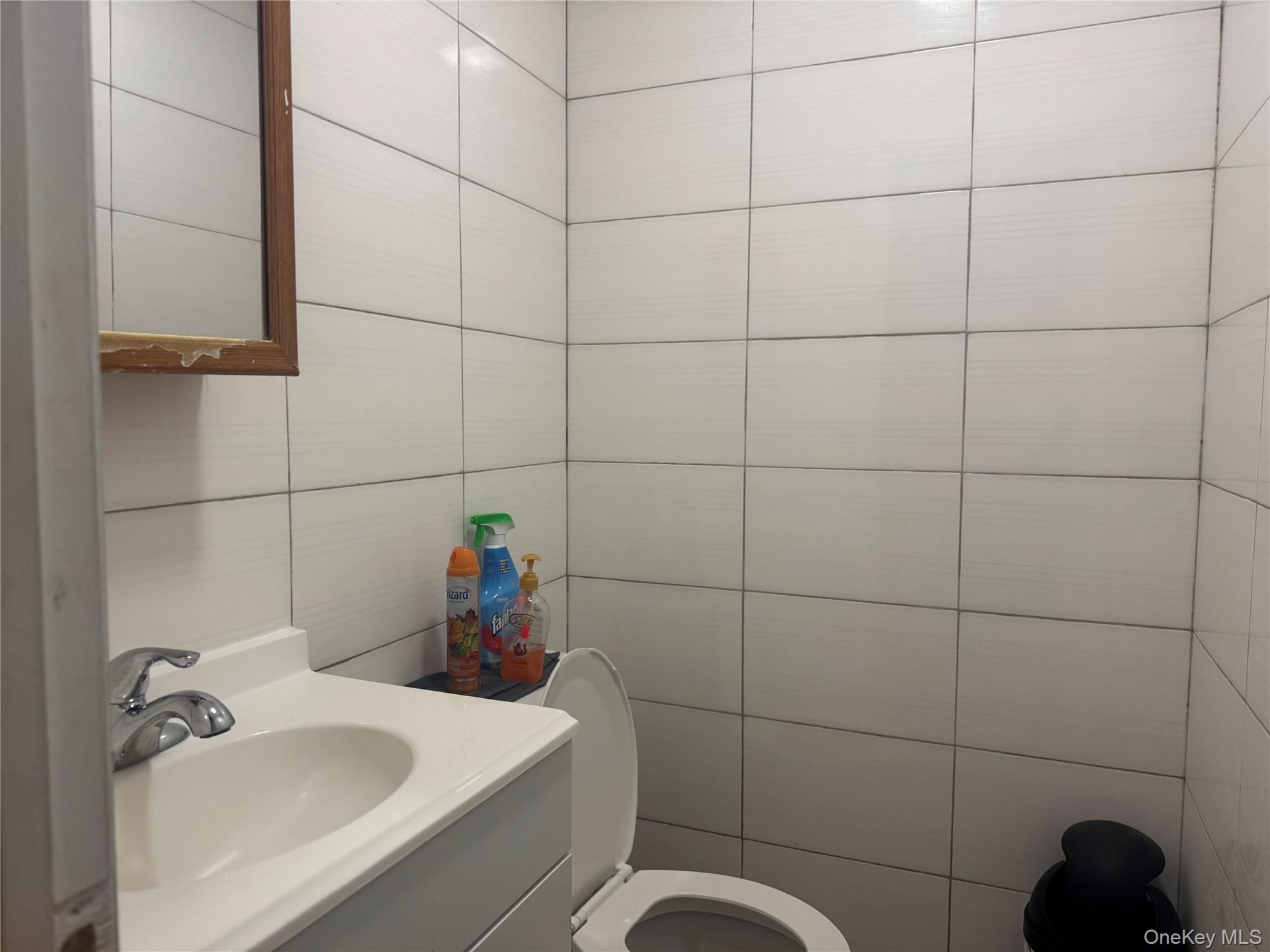Bathroom featuring vanity and tile walls