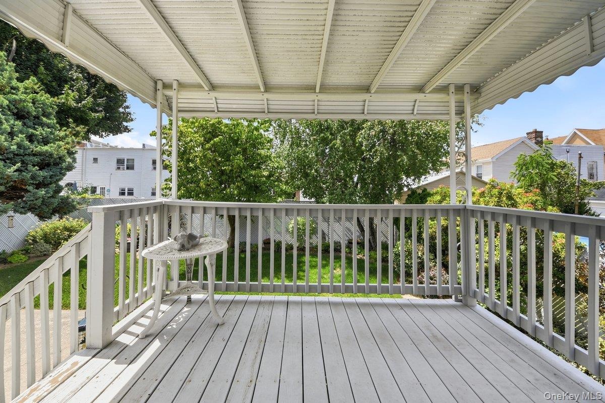 Expansive outdoor deck off of the kitchen, featuring composite decking, a protective overhead covering