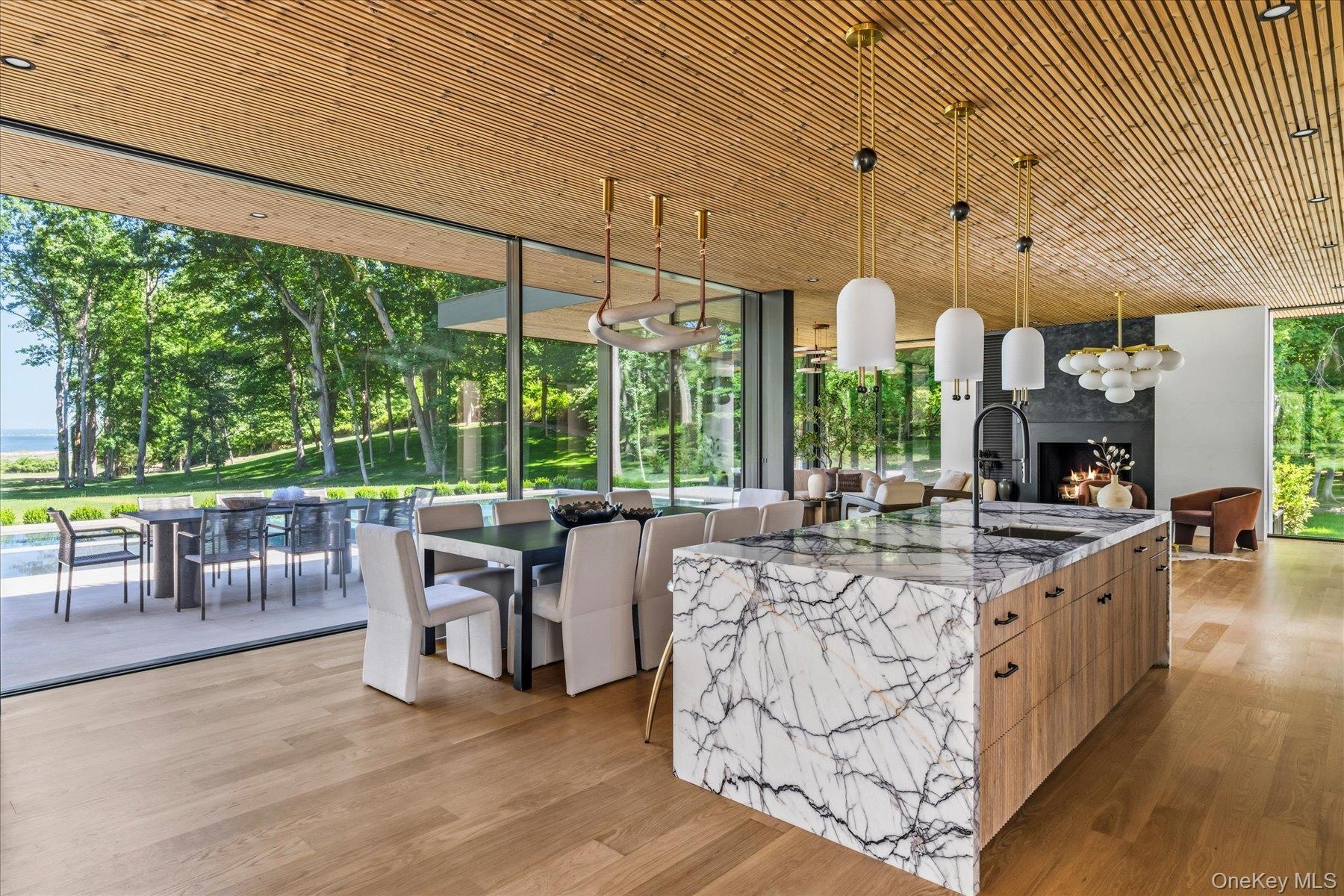 Open concept living with rich natural materials carrying from the inside to outside seamlessly.