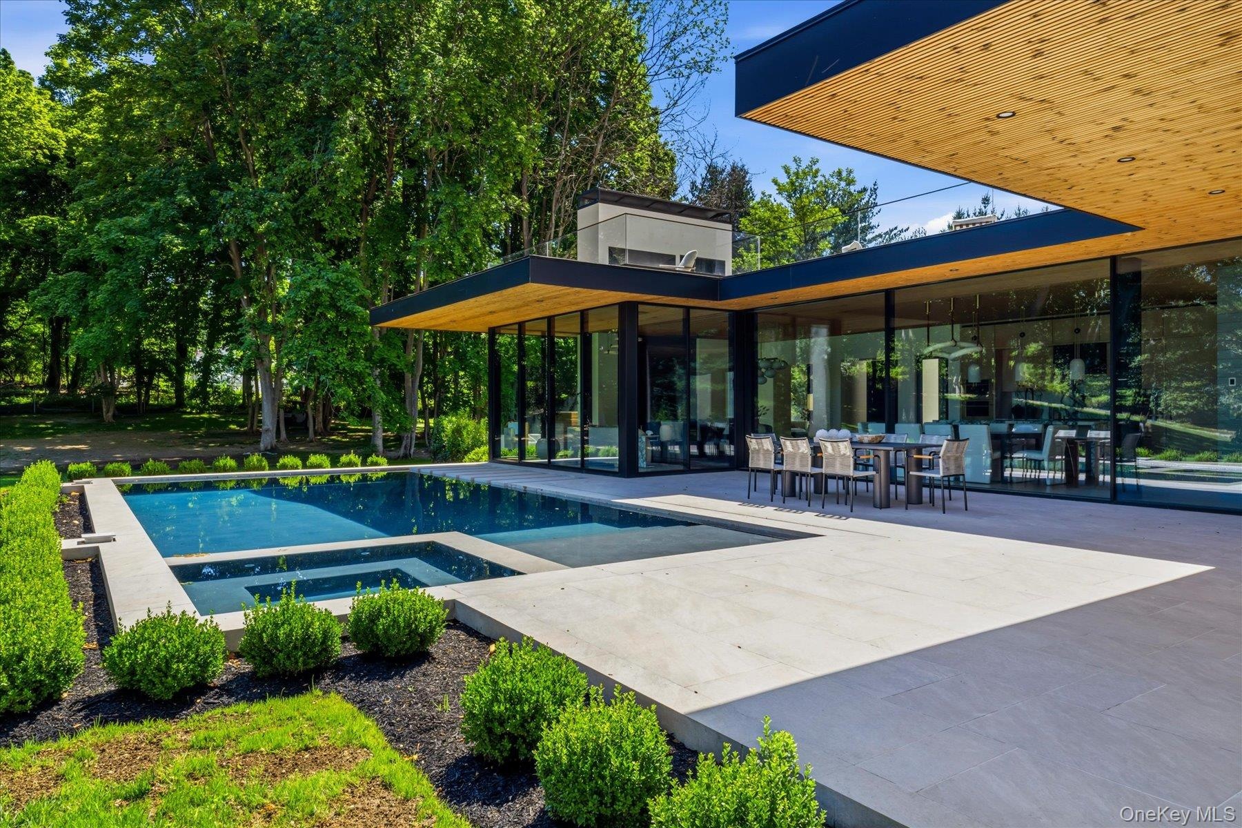Expansive outdoor terrace with pool, outdoor seating and outdoor kitchen