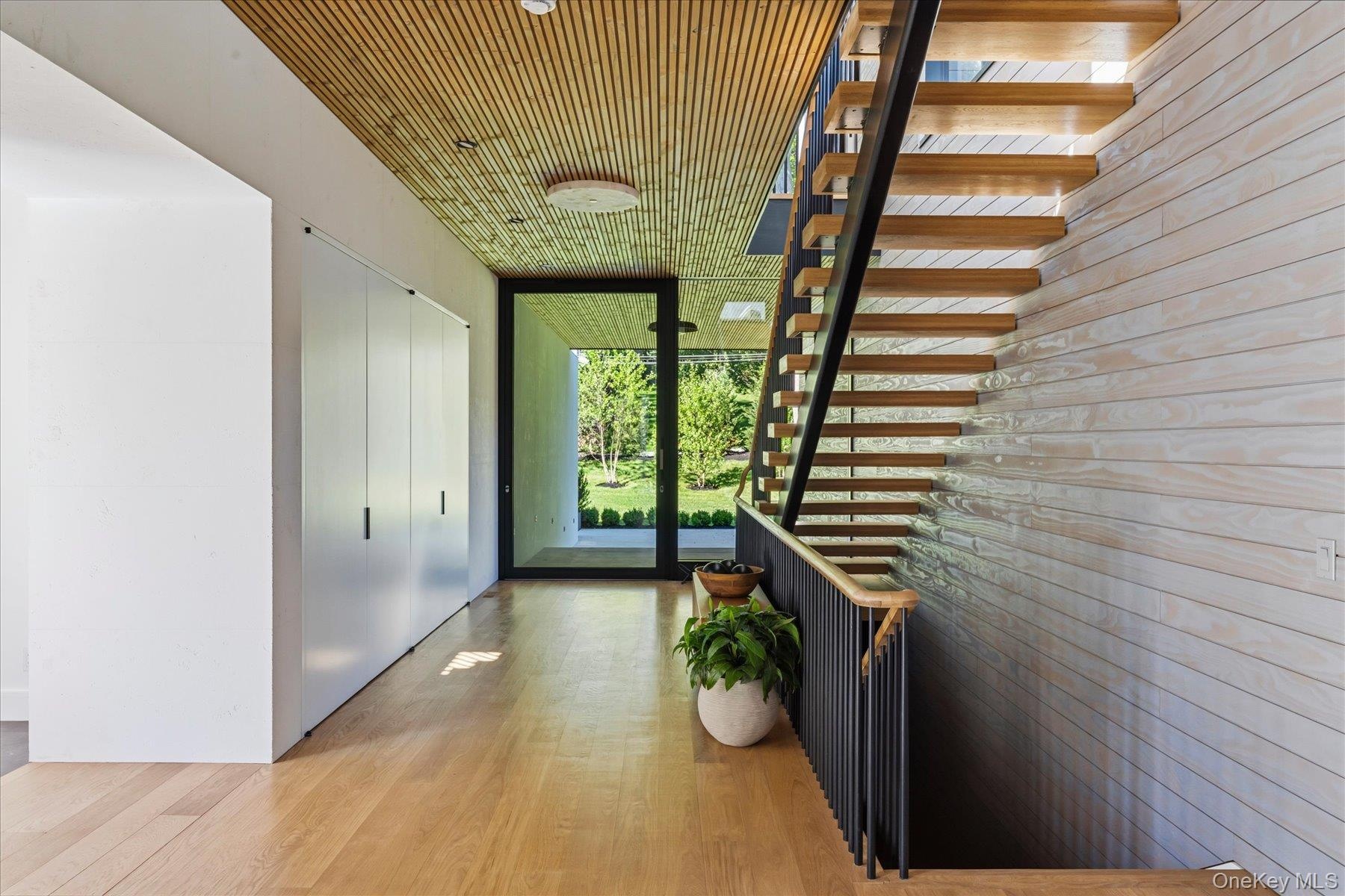 Stunning White Turkish Limestone Walls, Luna wood ceiling and Accoya wood siding that seamlessly flows from the inside to outside.