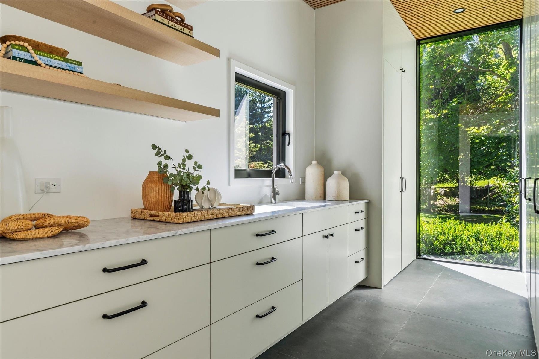 Mudroom/Laundry Room with extensive storage and additional preparation area
