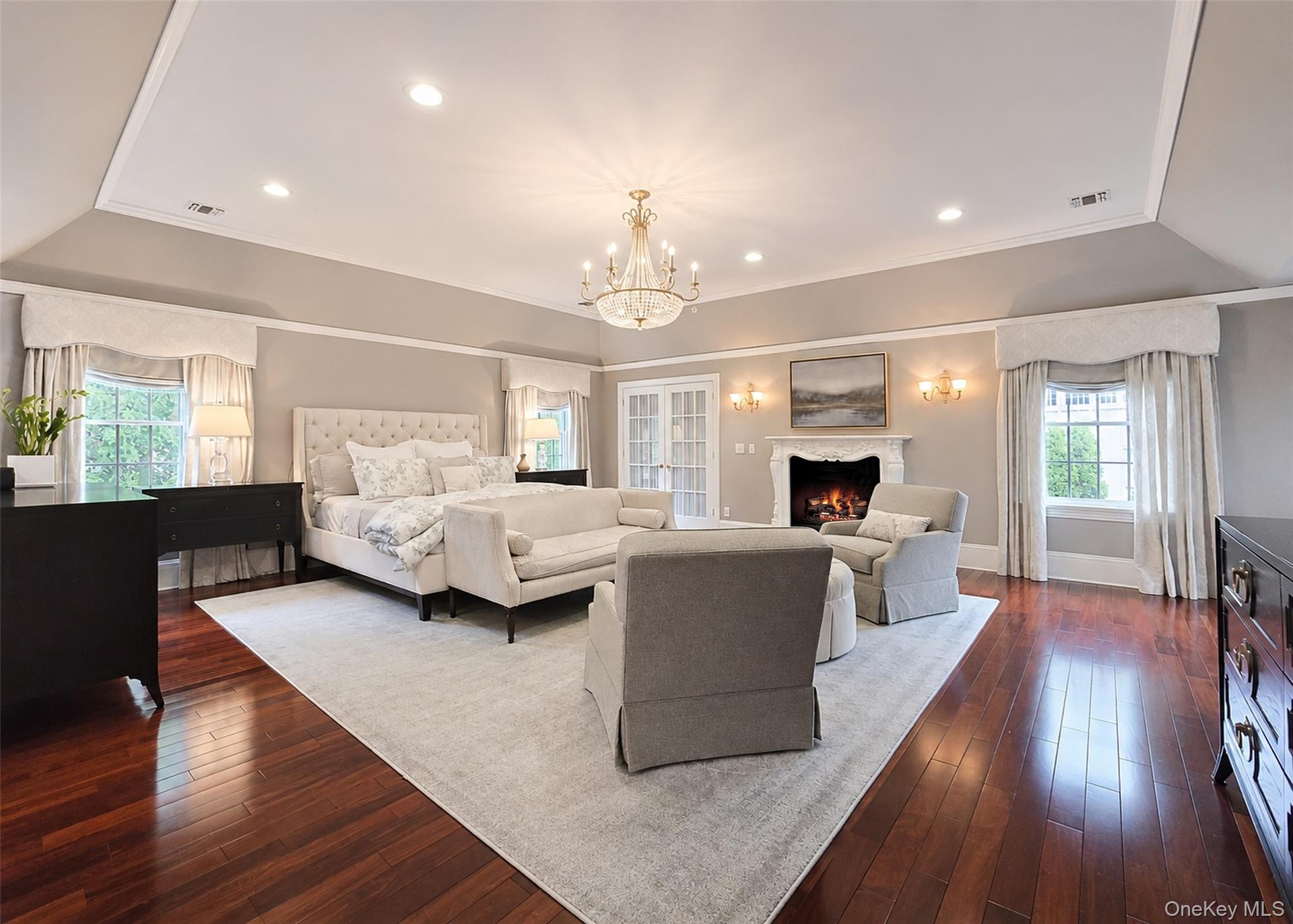 Masterfully Designed Primary En Suite with his/hers walk-in closets, fireplace and office