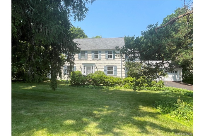 Welcome to 50 Ludlow Drive, classic center hall colonial wth 4 bedrooms, 2 full baths, 2 half baths and a lush acre of property on a sought after cul-