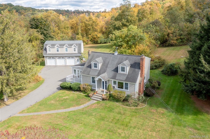 View of front of house with a front yard and driveway