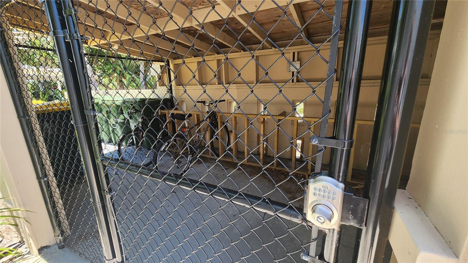 The free, secure bike storage is immediately in front of this condo's covered parking space
