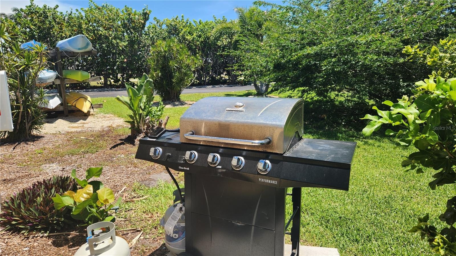 Out front, directly next to this condo's covered parking space, is a shared gas grill and kayak storage