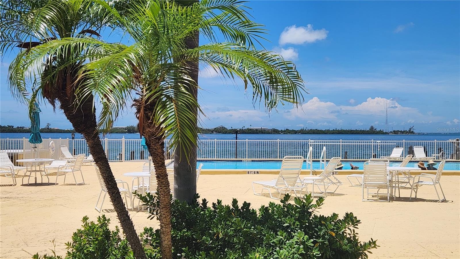 The expansive pool and surrounding pool deck offer plenty of seating and lounge chairs