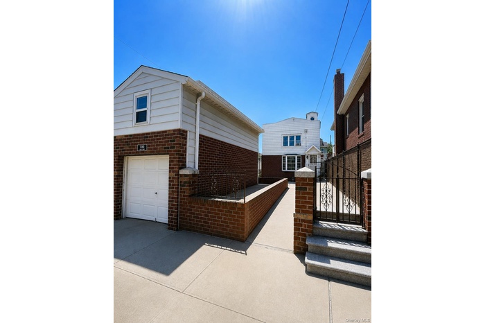Front view of home & garage with Home situated at rear of property.