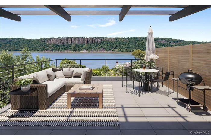 Elevated living at its finest—expansive rooftop terrace featuring panoramic views of the Hudson River and the Palisades