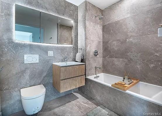 Modern bathroom featuring full-height stone-look tile walls and flooring