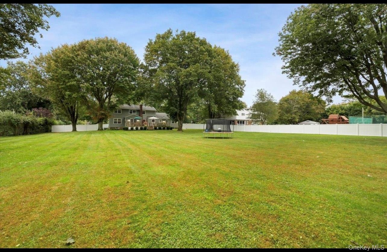 View of yard featuring a trampoline