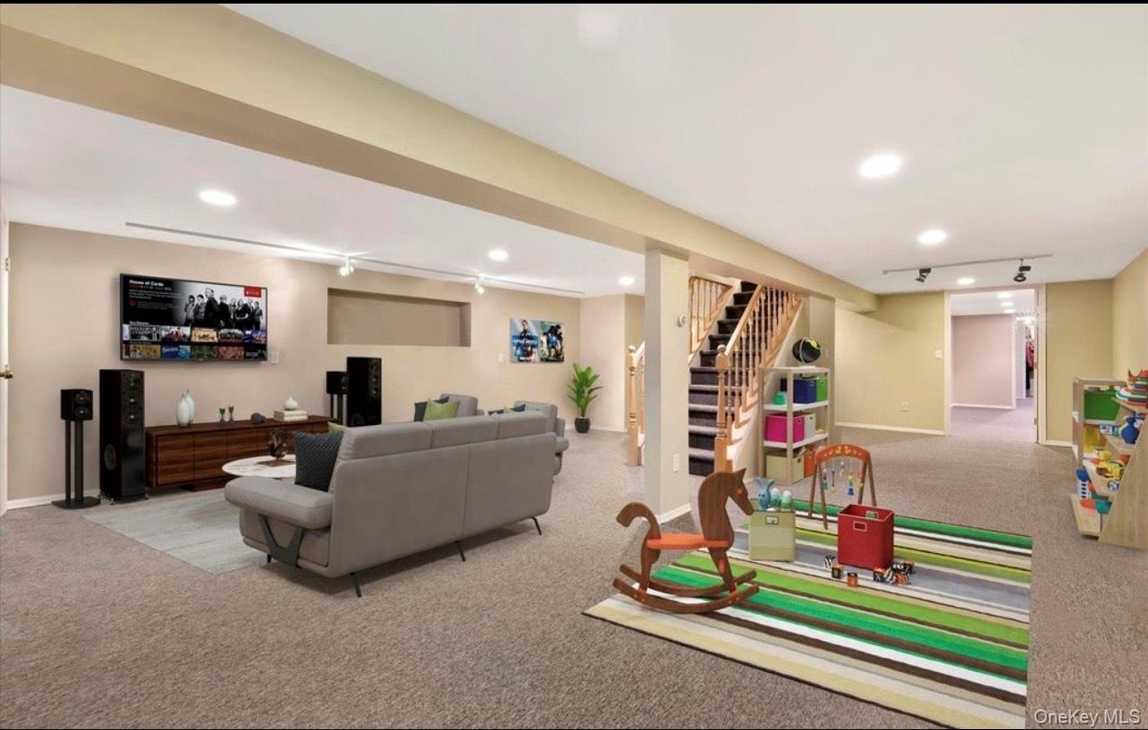 Living area featuring carpet flooring, stairway, recessed lighting, and rail lighting