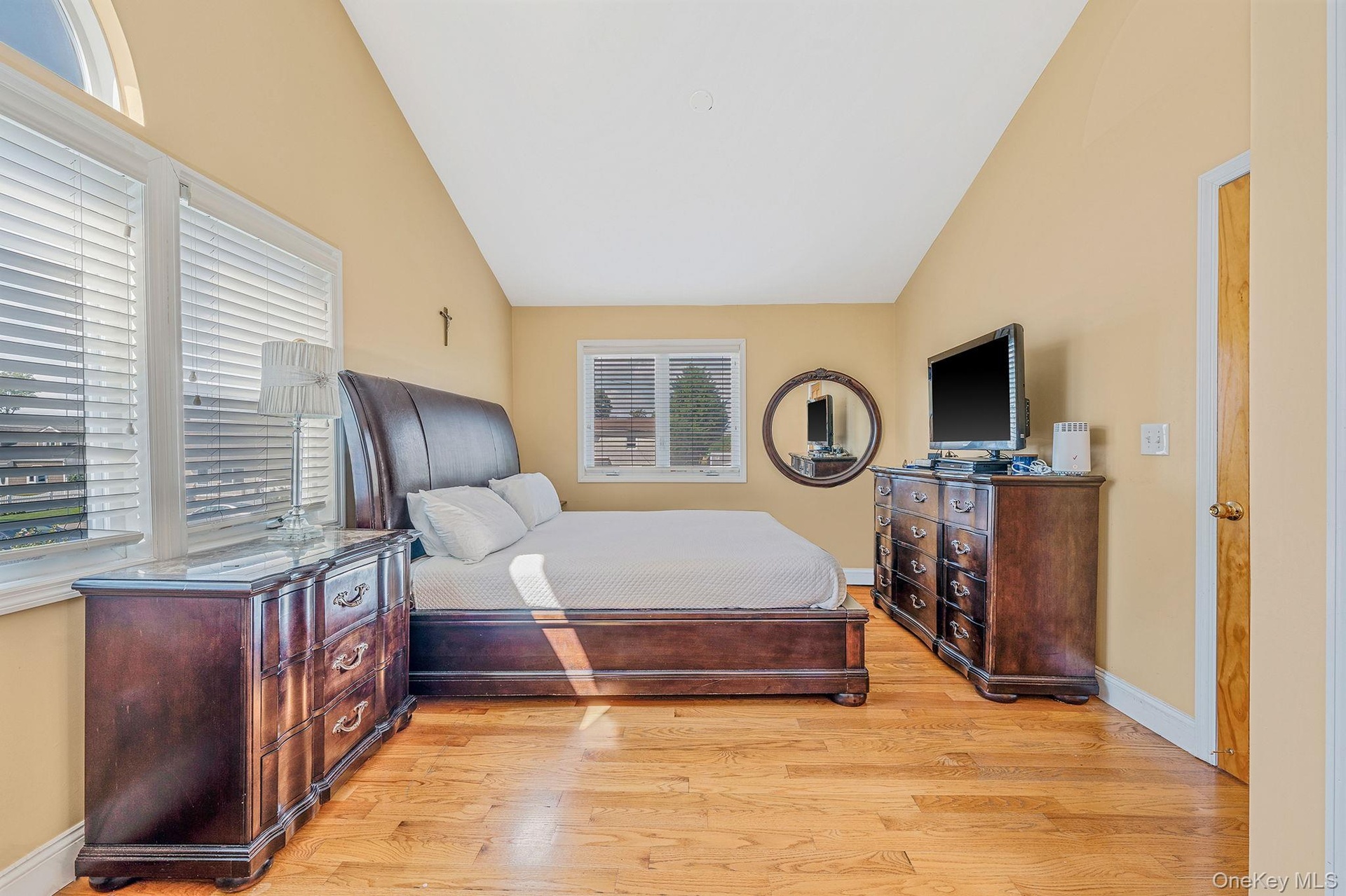 Bedroom featuring lofted ceiling and light wood-type flooring