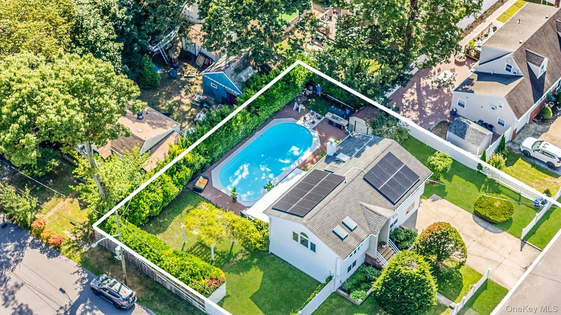 View of subject property with property parcel outlined and a pool
