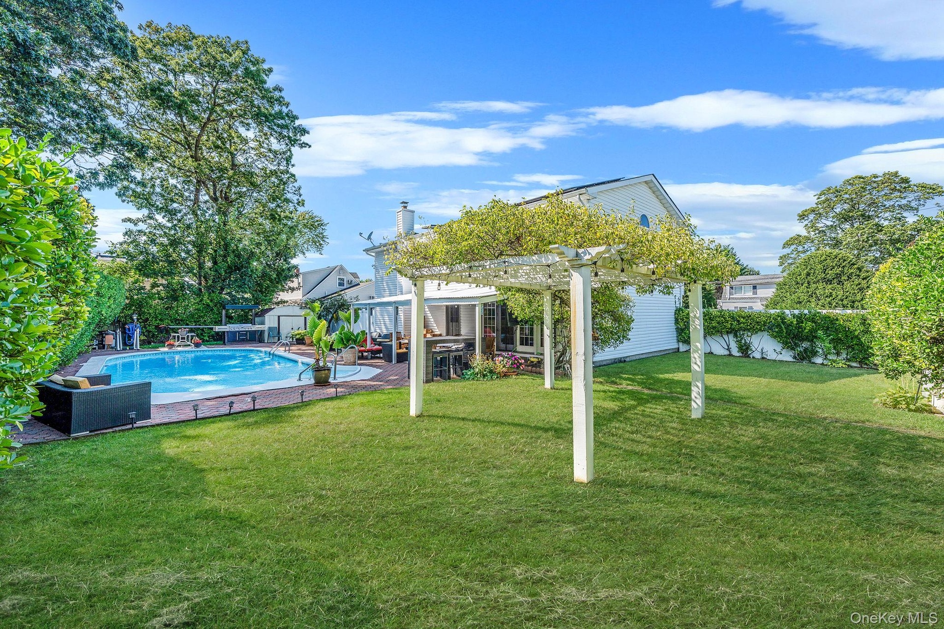 View of pool featuring a pergola and a patio