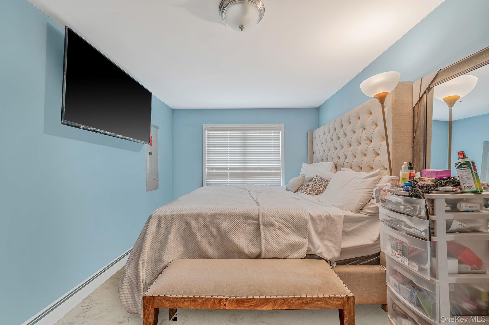 Bedroom with a baseboard heating unit and baseboards