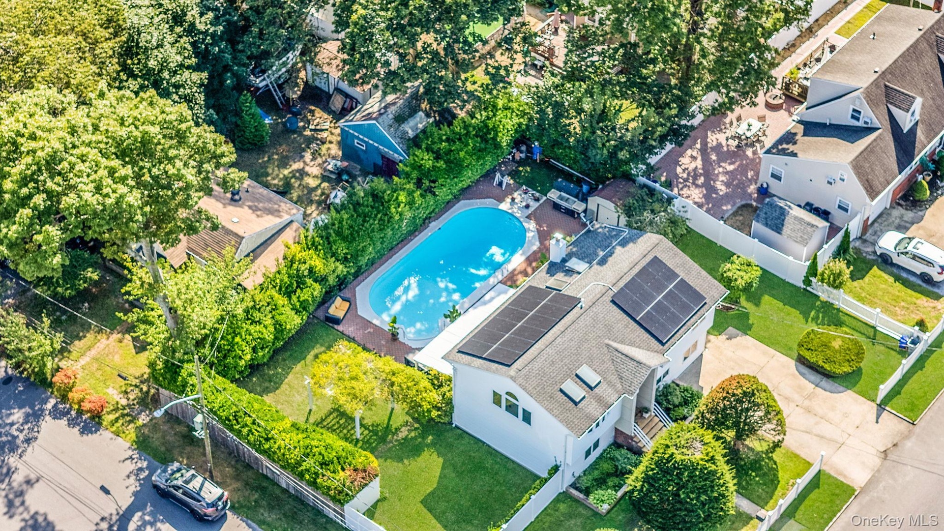 Aerial view of property and surrounding area featuring a pool