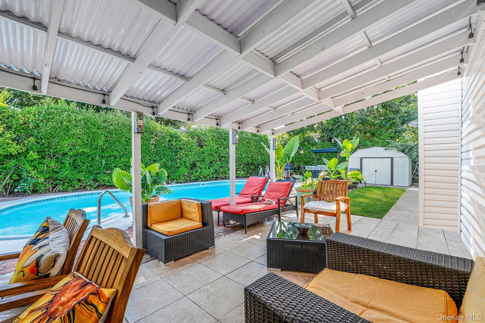 Fenced backyard featuring outdoor lounge area, a patio area, a storage shed, and view of wooded area