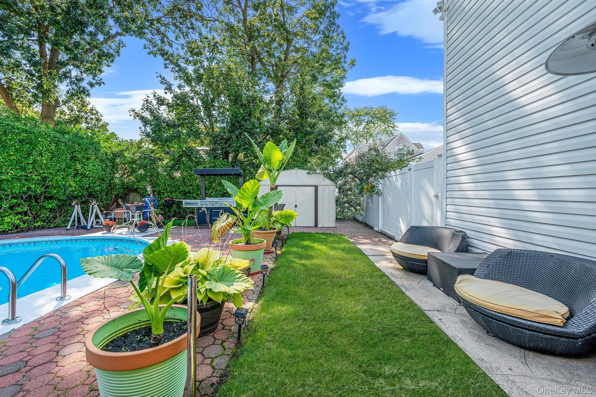 Fenced backyard with a patio and a storage shed