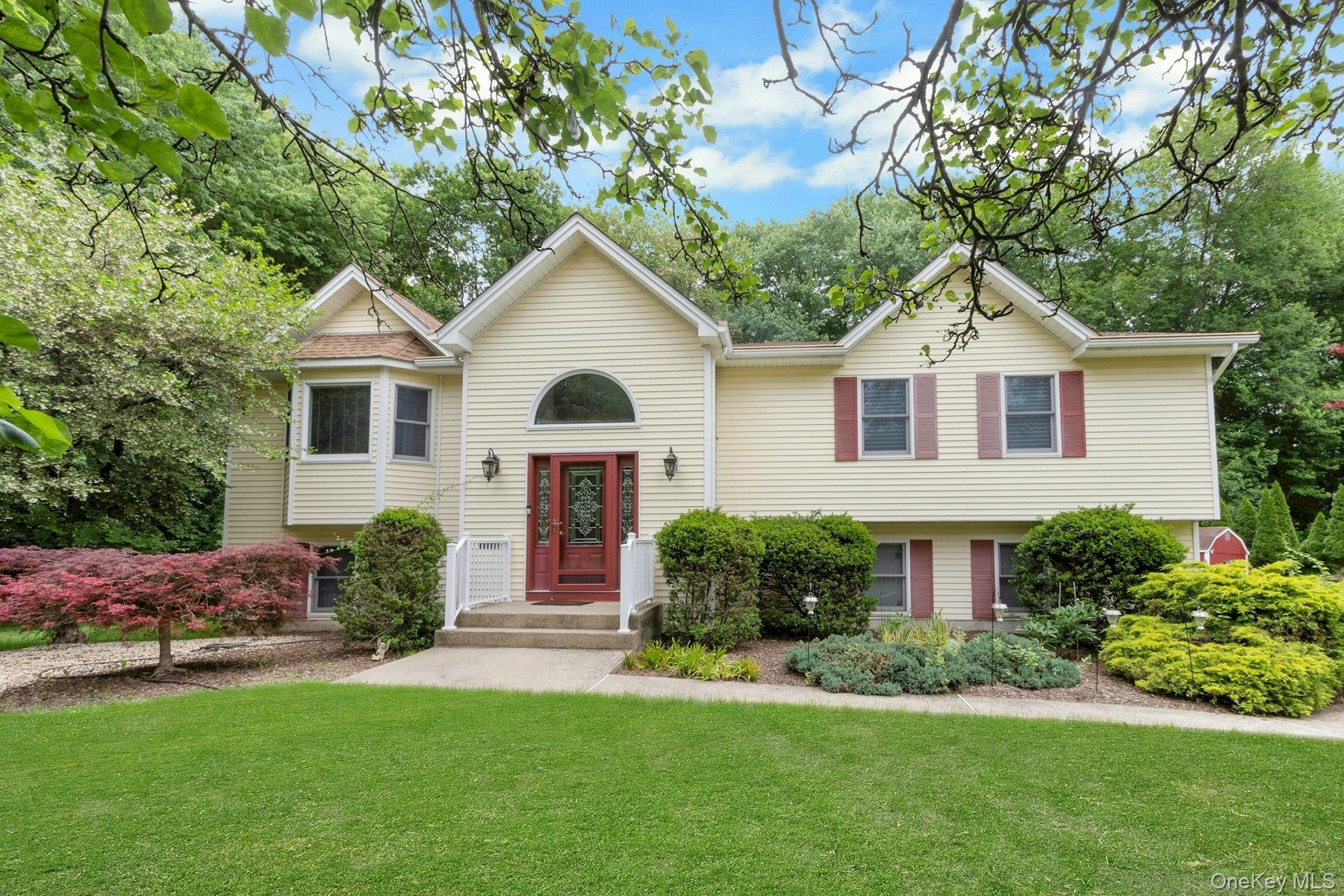 Front of home with landscaping, front lawn, end of a cul-de-sac