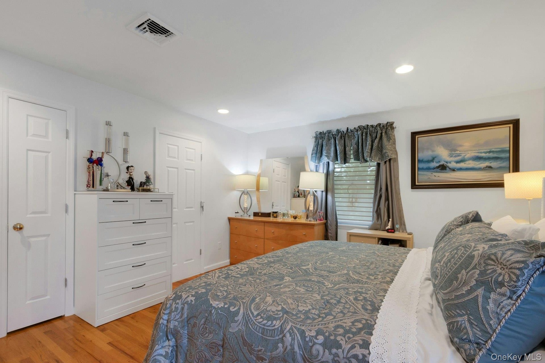 Primary bedroom with doors to ensuite bath and walk in closet