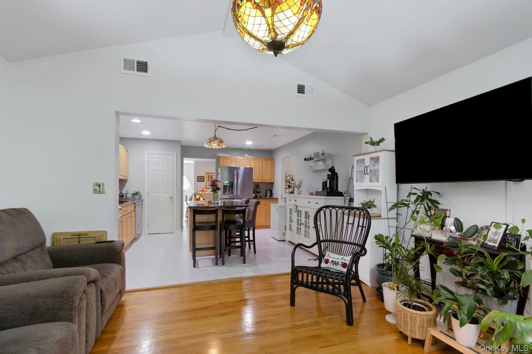 Family room with hardwood floors open layout to kitchen