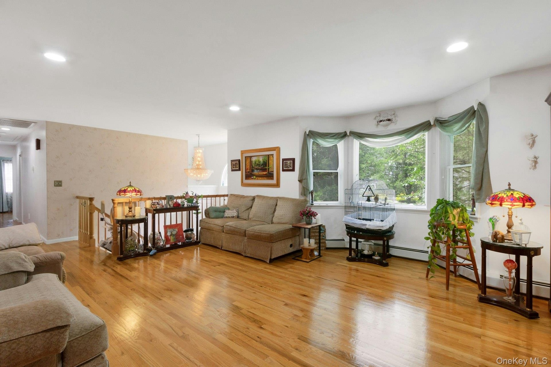 Living room with hardwood floors, recessed lighting, sunlight