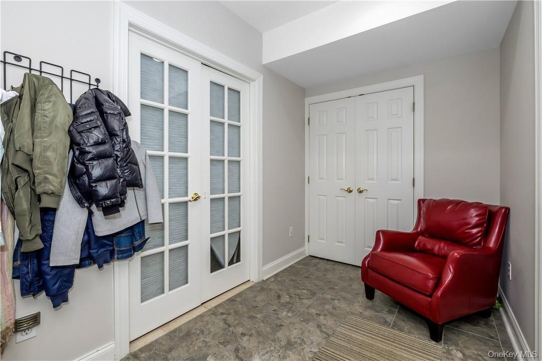 Mudroom w/ door to Garage and Door to playroom and bathroom and den / office.