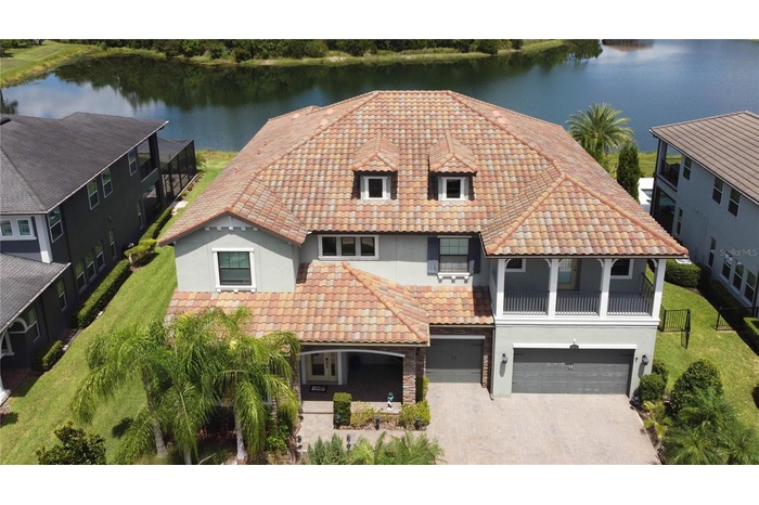 Aerial showing beautiful tile roof, pond in the back