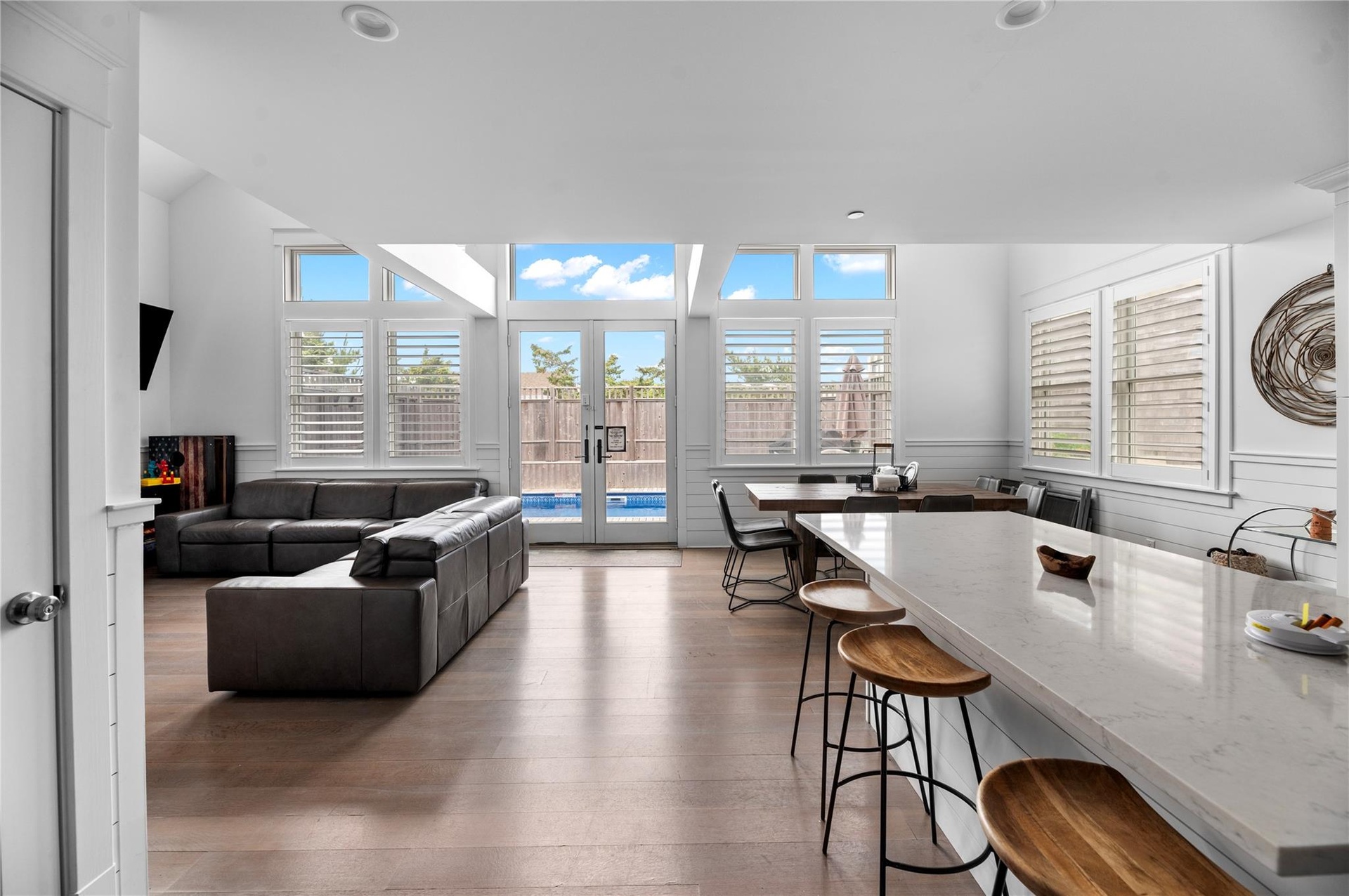 Living room with french doors, wood-type flooring, and plenty of natural light