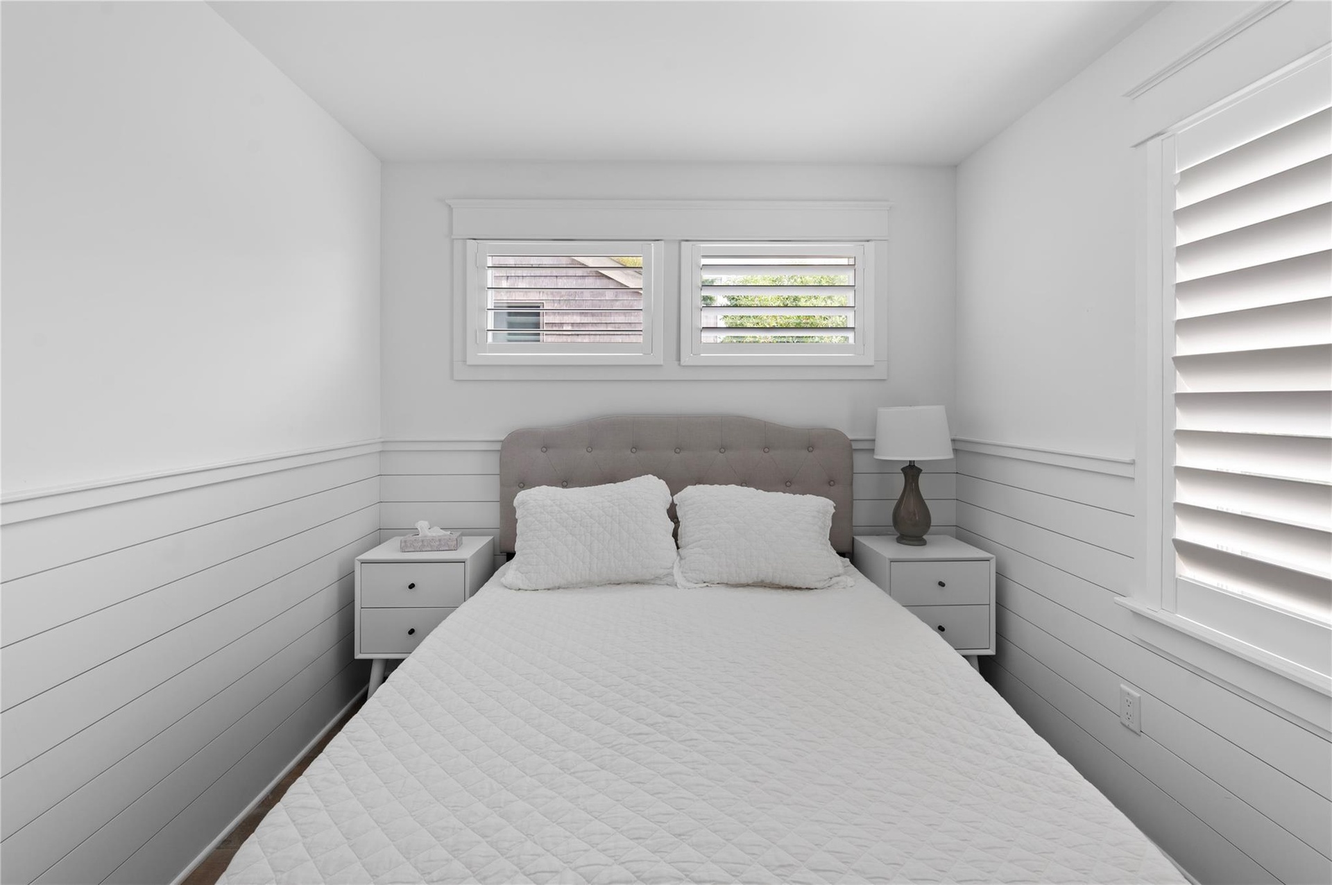 Bedroom featuring wooden walls
