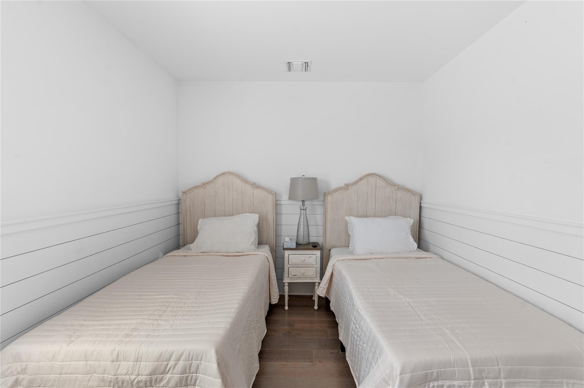 Bedroom with dark hardwood / wood-style flooring
