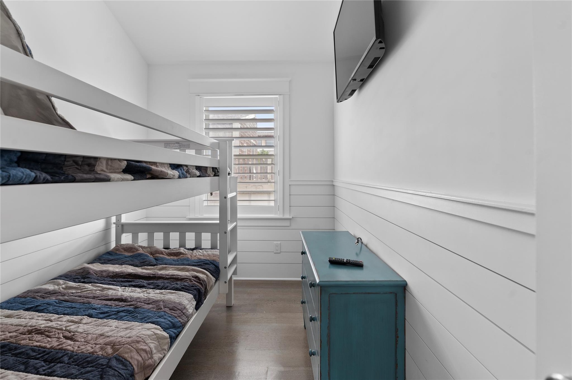 Bedroom with dark hardwood / wood-style flooring