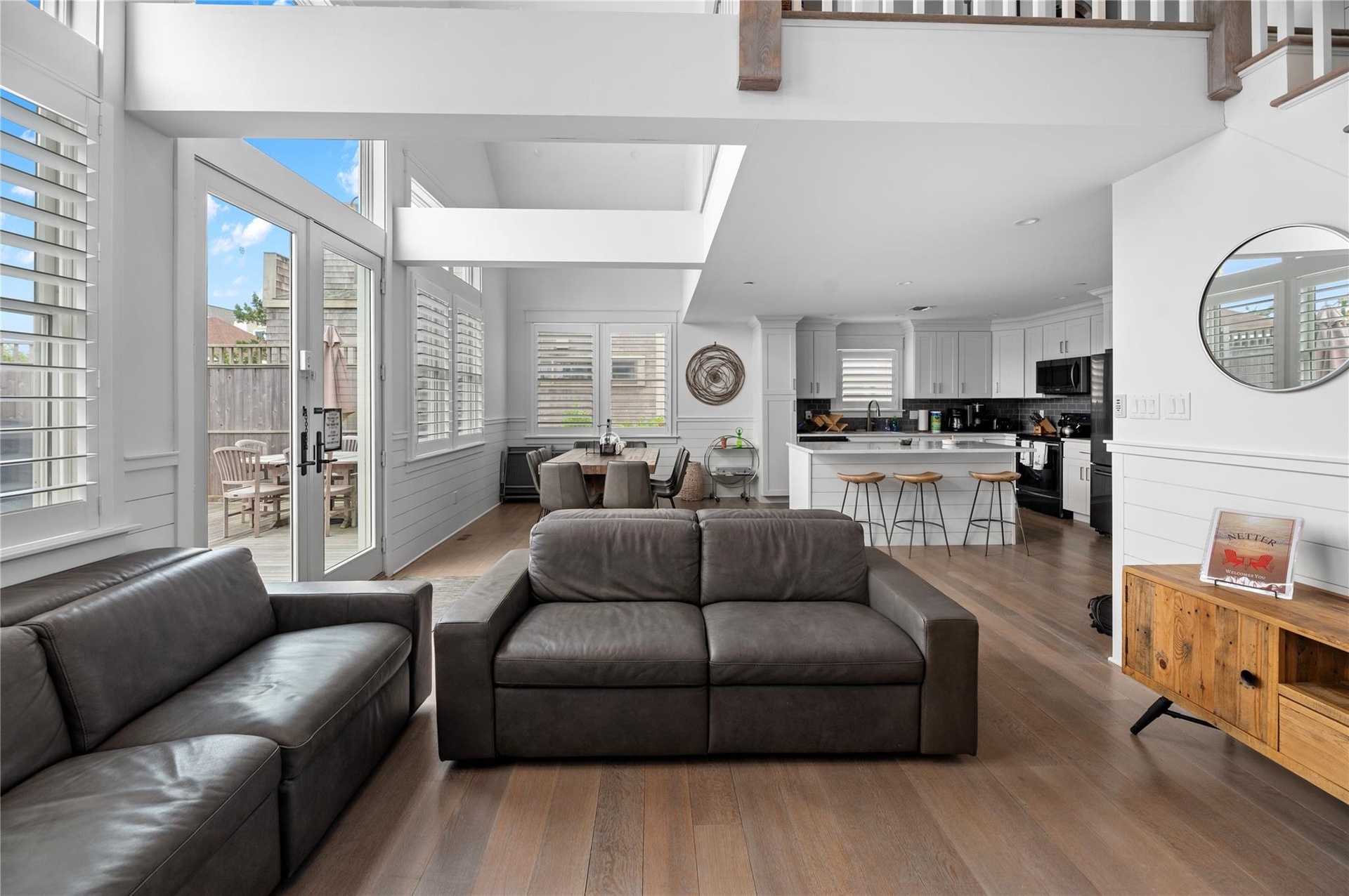 Living room with dark hardwood / wood-style flooring, sink, a towering ceiling, and french doors
