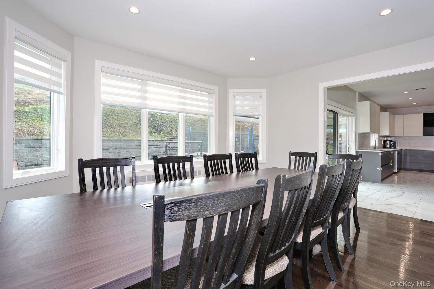 Dining area with light wood-type flooring and recessed lighting
