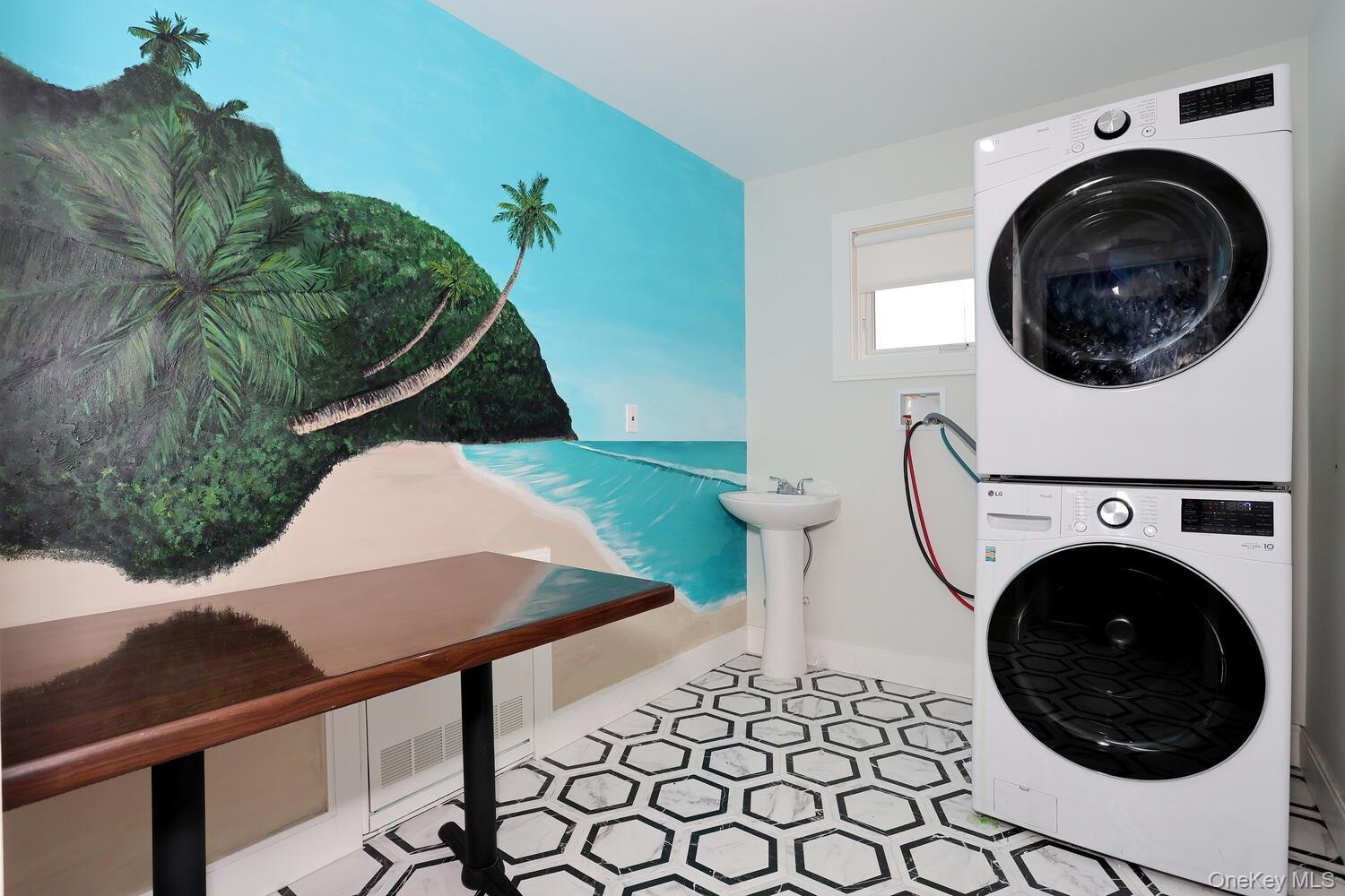 Laundry room with stacked washer / dryer and tile patterned floors