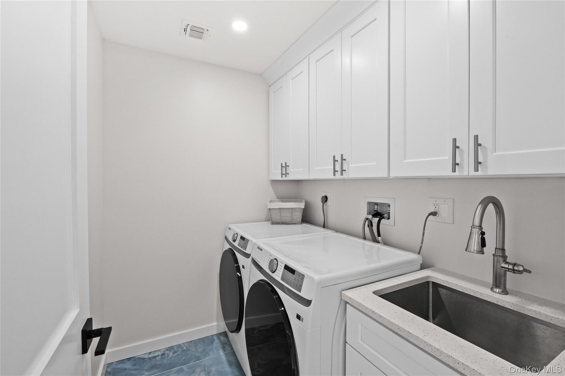 2nd floor laundry room equipped with additional sink and plenty of storage!