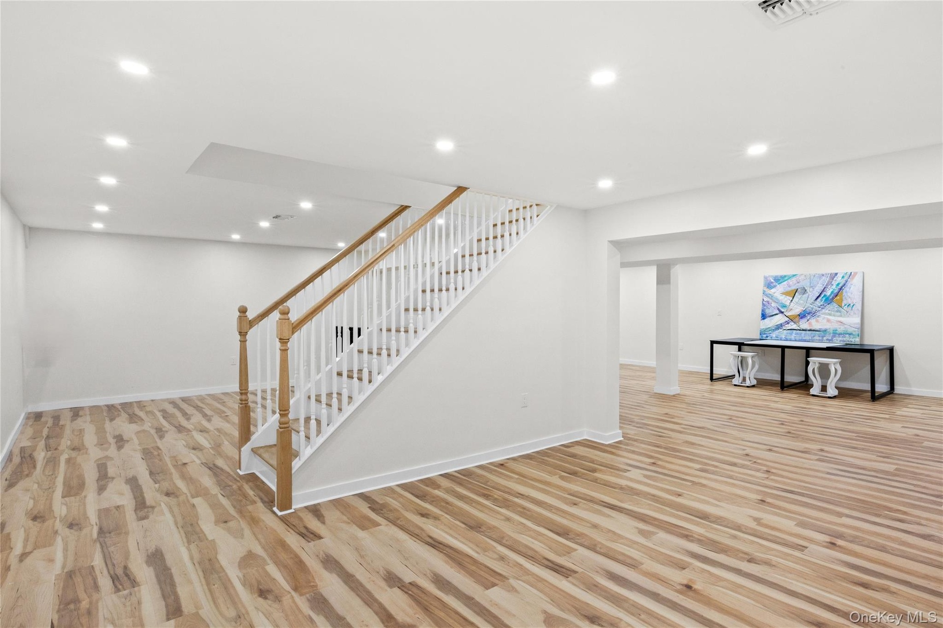 Big basement with 4 oversized egress windows wood floor look luxury vinyl