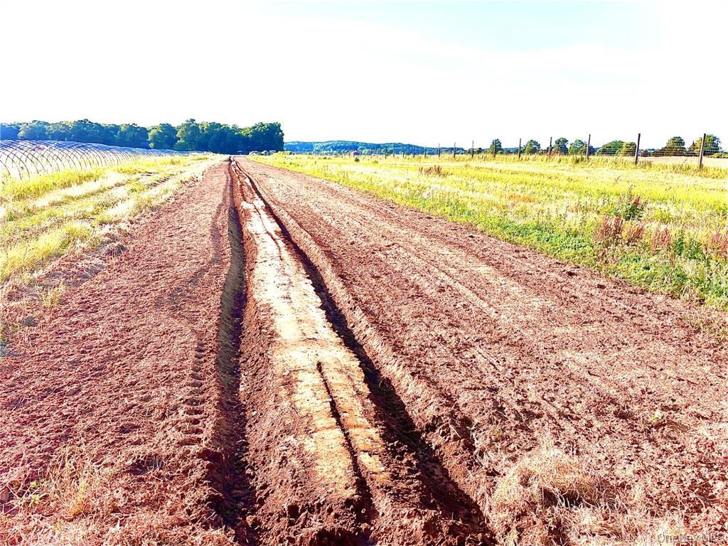 View of dirt / gravel road featuring a view of countryside