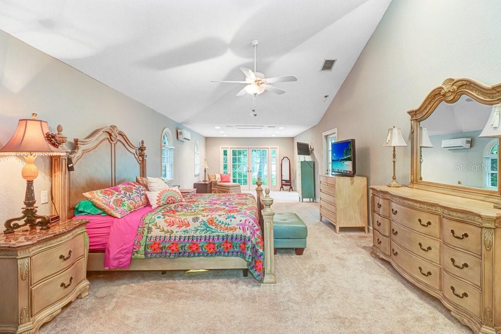 Expansive master bedroom 14' x 37' with vaulted ceilings and large sitting area and french doors out to pool/patio area.