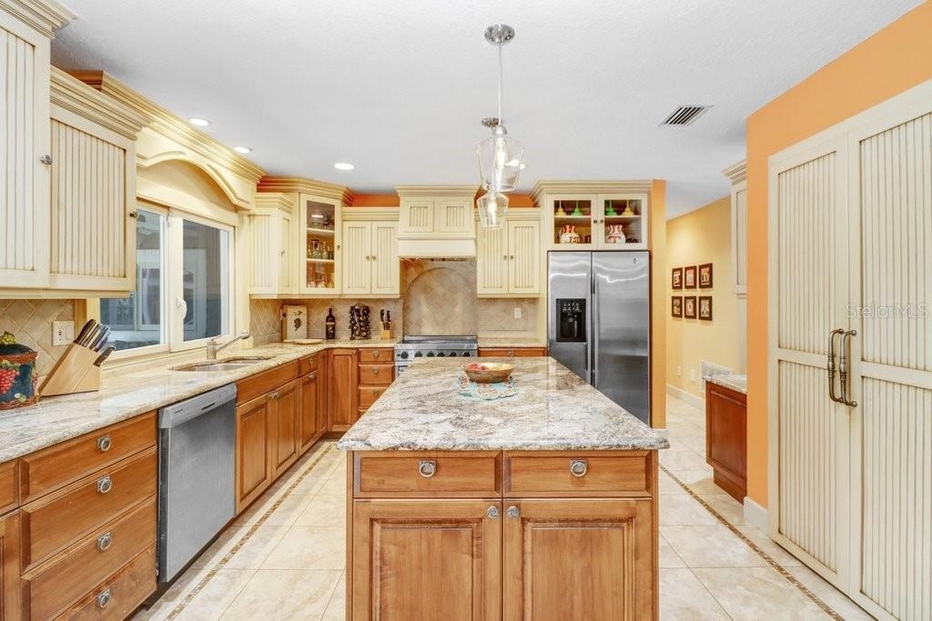 Beautiful glazed custom cabinets with granite counter tops walk in pantry , Stainless steel appliances which includes a Viking Range.