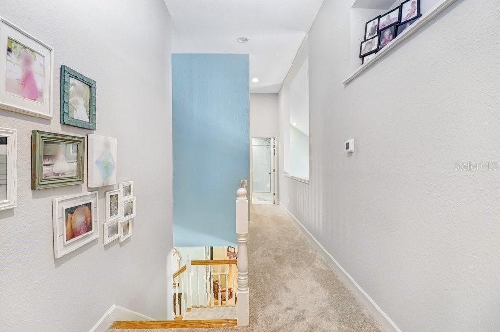 Hallway with pot shelves and open area to the Great Room