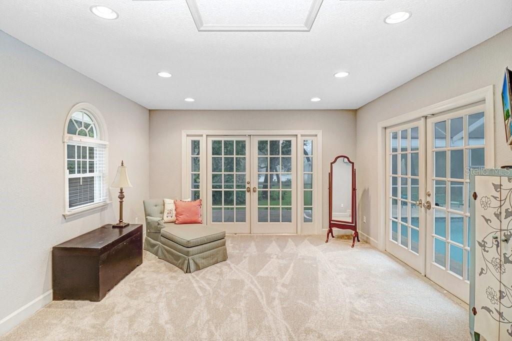 Master bedroom has large sitting area with French doors to pool/patio area.  This area can also be used for yoga,or office space etc.