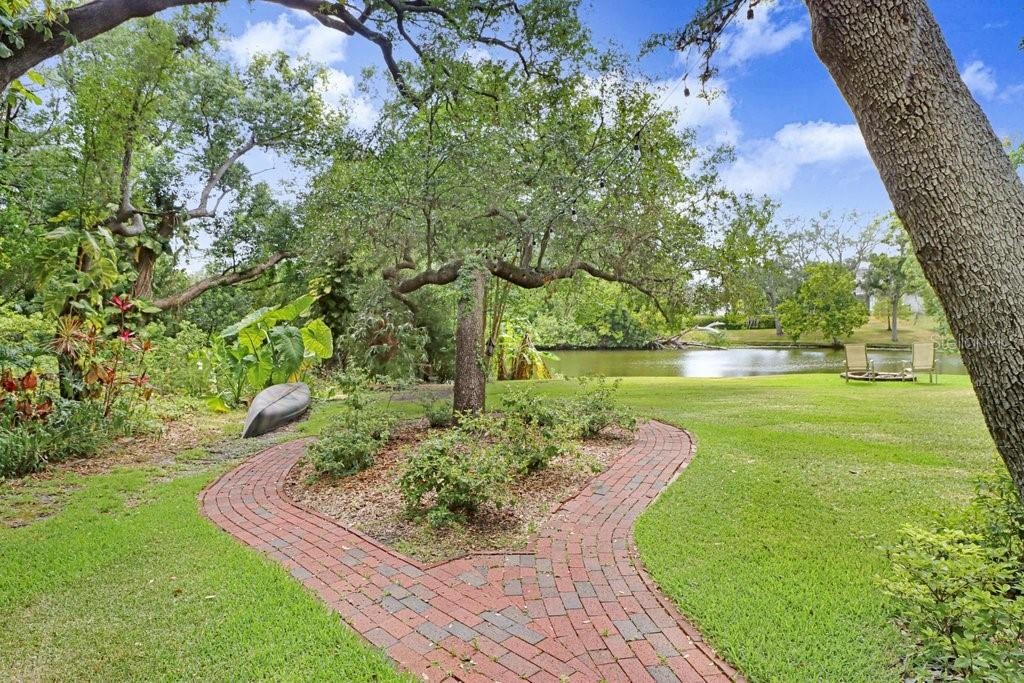 Brick paver paths leading to lake area.