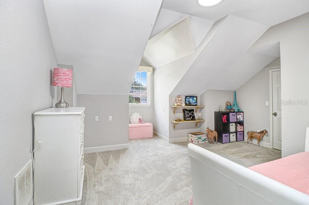 Another oversized bedroom with dormer window area and walk-in closet.