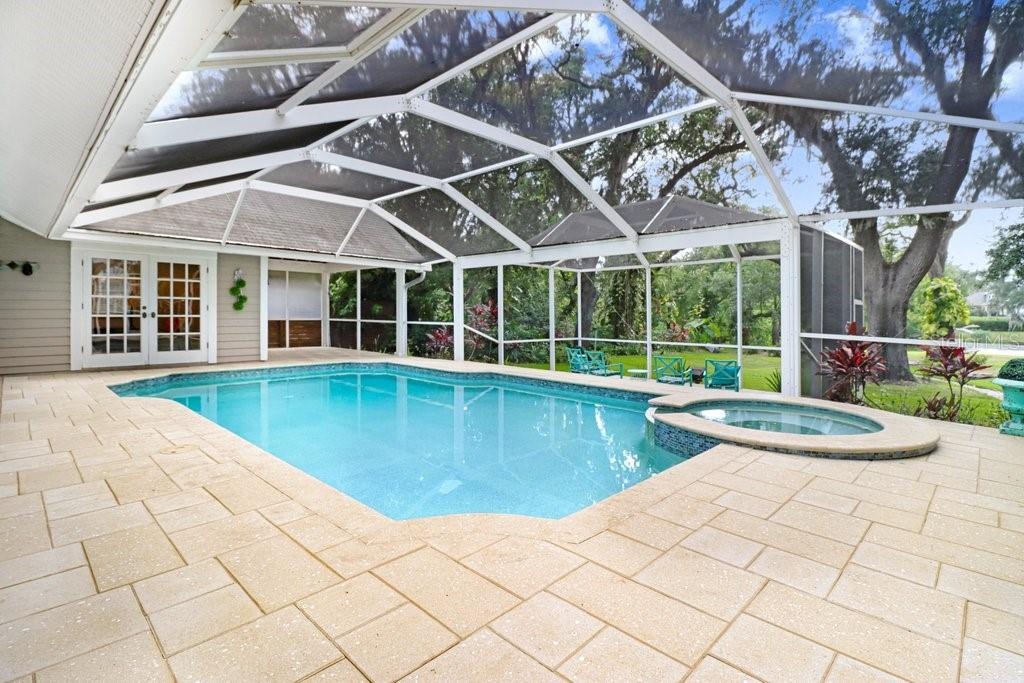 Amazing views of backyard and step-down patio area overlooking the backyard and lake.