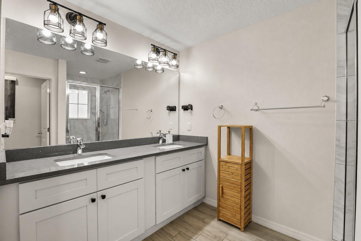 Primary en-suite bathroom featuring dual vanities, generous counter space, and modern finishes.